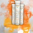 Three Cfizz tubes on a decorative stand with an orange and white abstract design in the background.