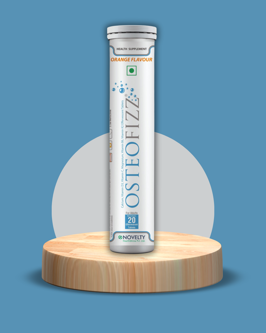 Osteofizz supplement tube on a wooden platform with a blue background